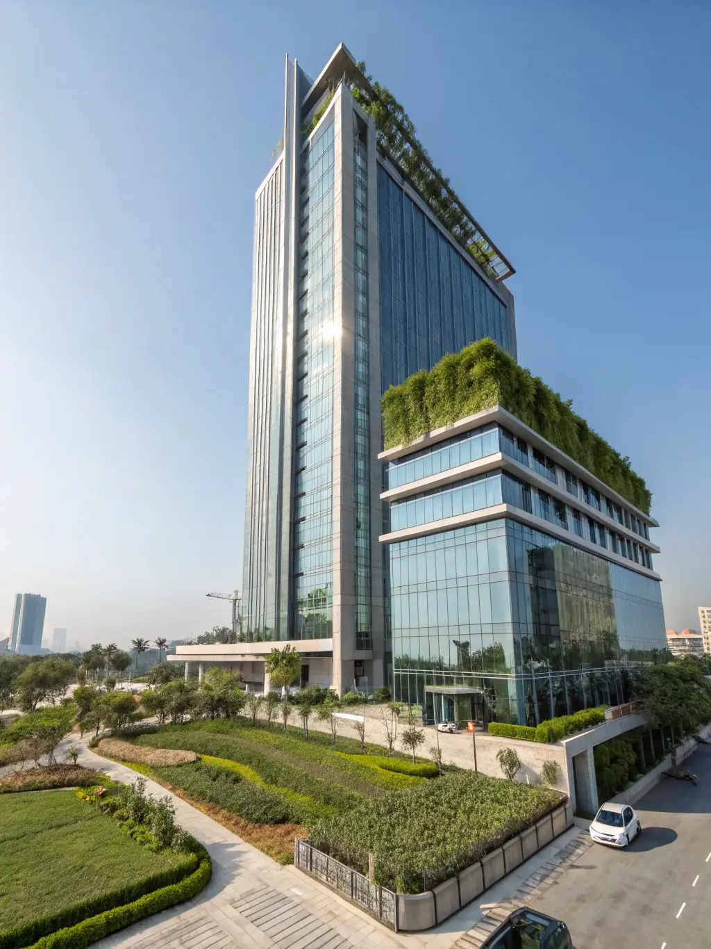 A modern, high-rise condominium building with a sleek glass facade, showcasing the architectural design of R&F Princess Cove against a clear blue sky.