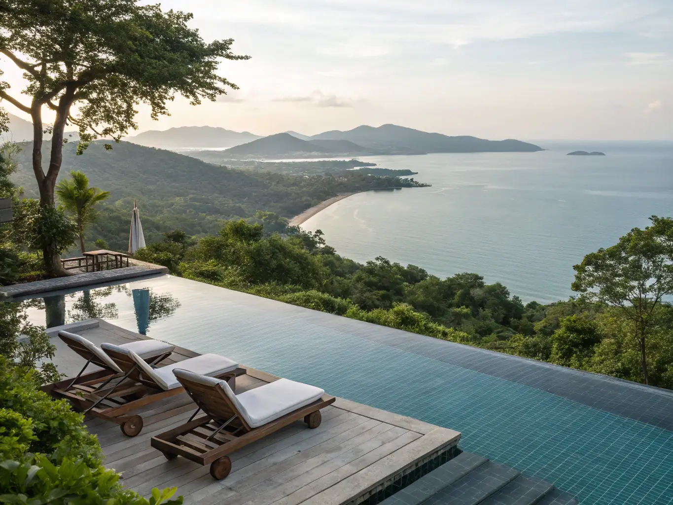 A high-angle, daytime shot of the R&F Princess Cove infinity pool, showcasing its sleek design and panoramic city views. The pool is surrounded by modern lounge chairs and lush landscaping, emphasizing the luxury and relaxation it offers to residents.